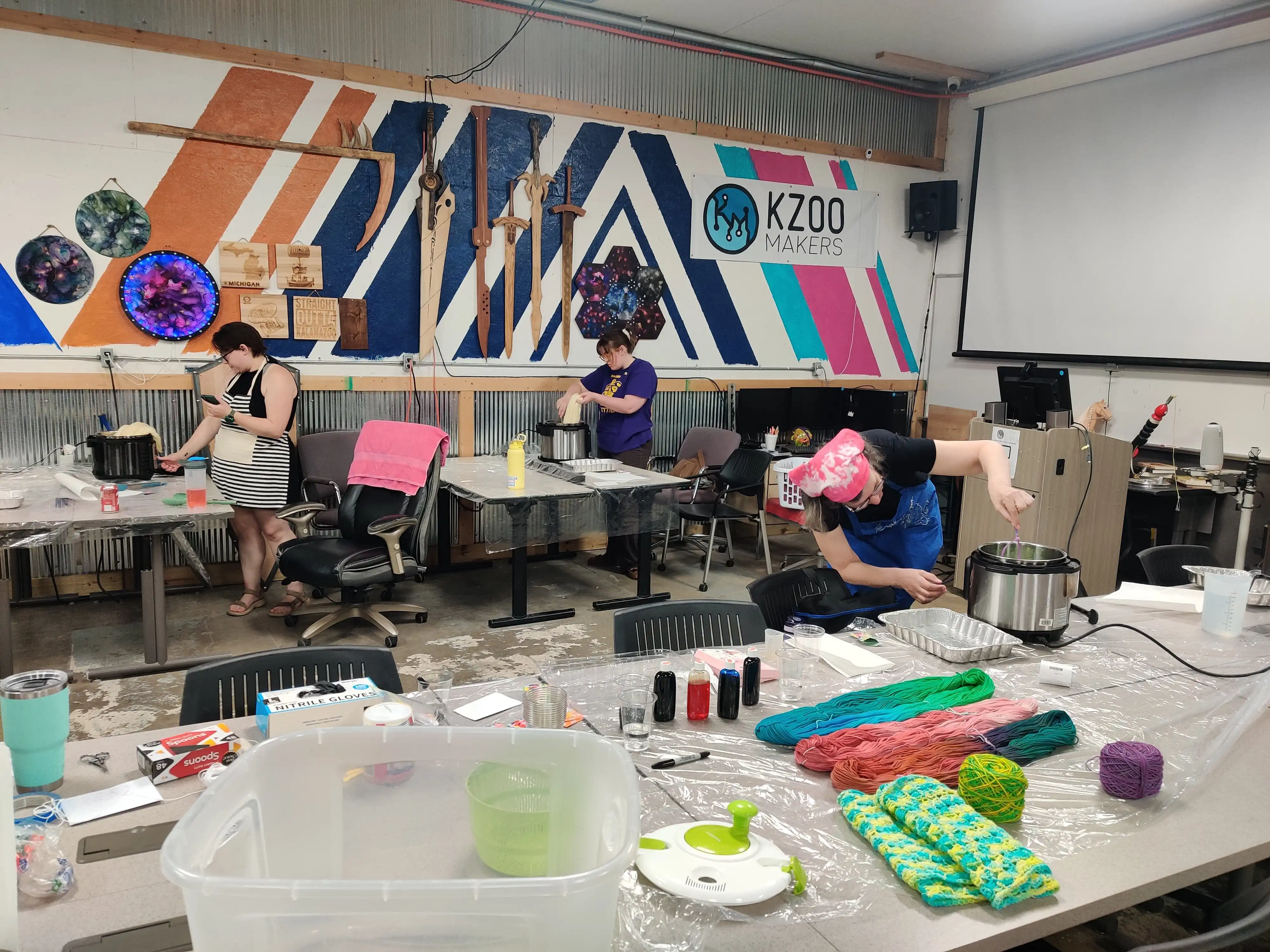 Instructor demonstrating yarn dyeing techniques at a workshop